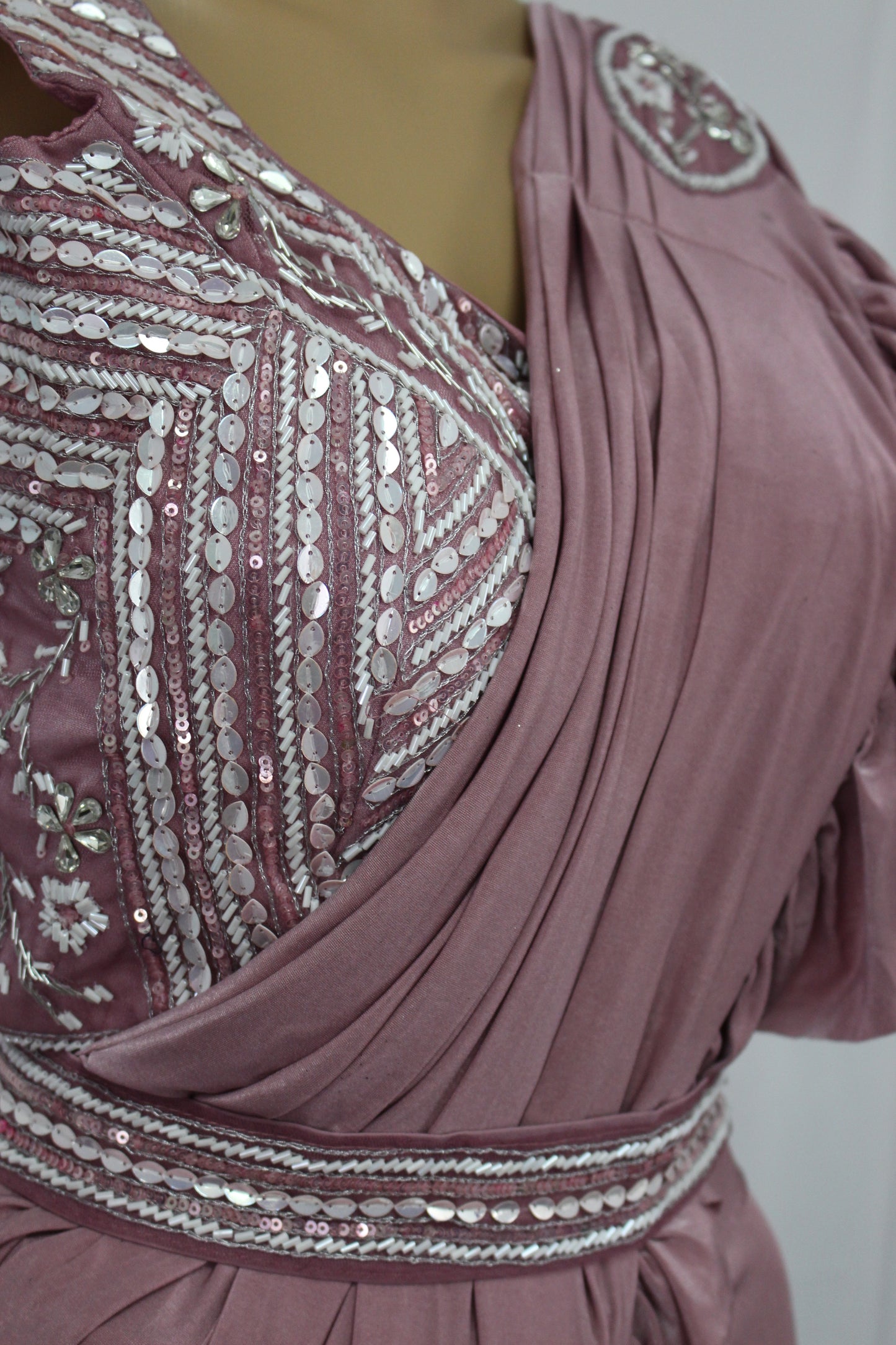 Elegantly designed deep pastel pink saree with hand made blouse and belt