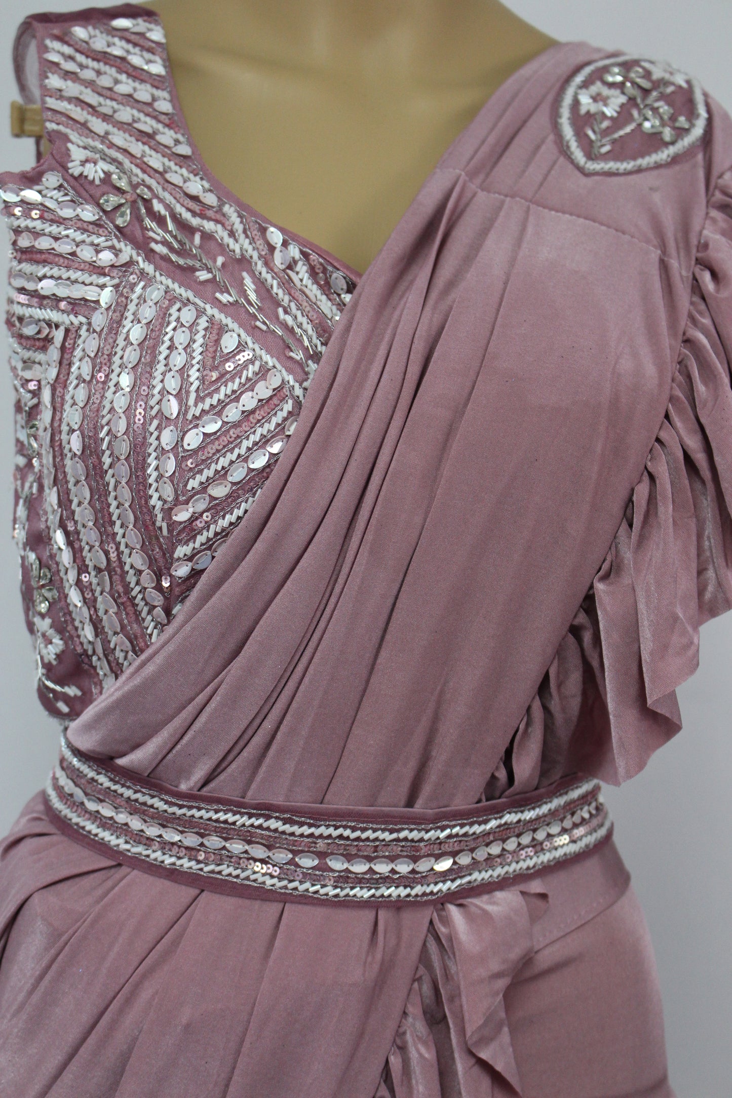Elegantly designed deep pastel pink saree with hand made blouse and belt